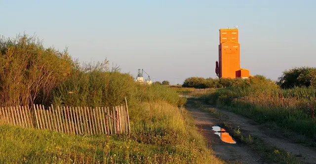 Orange grain elevator at sunset