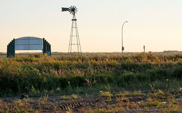 Windmill and town welcome sign at the edge of Stoughton