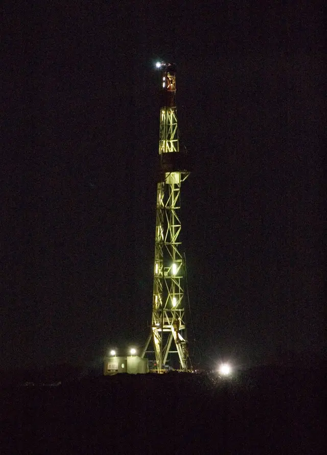 Oil drilling rig at night